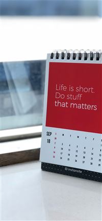 spiral freestanding calendar on white surface wallpaper