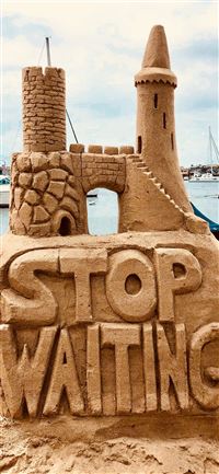 sand castle beside body of water wallpaper