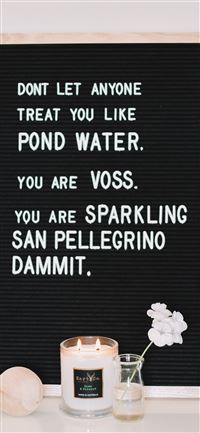 quote on table near lighted candle wallpaper