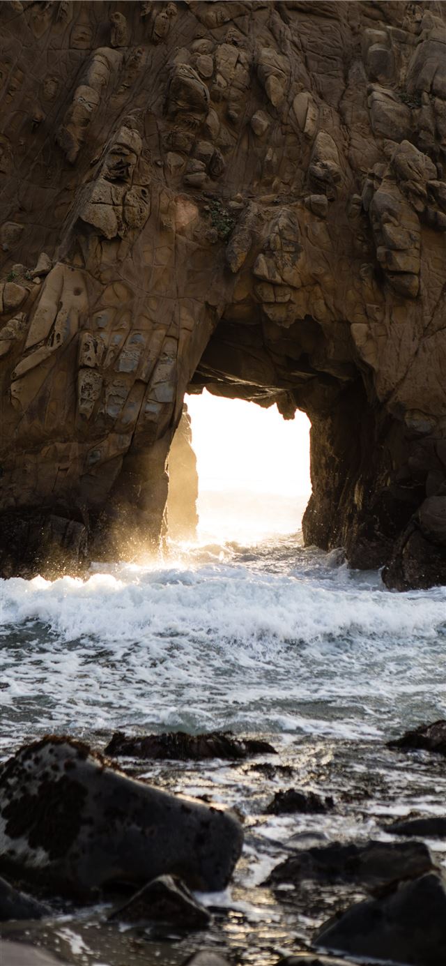 1125x2436 brown rock formation near body of water during day... -  iPhone X Wallpaper