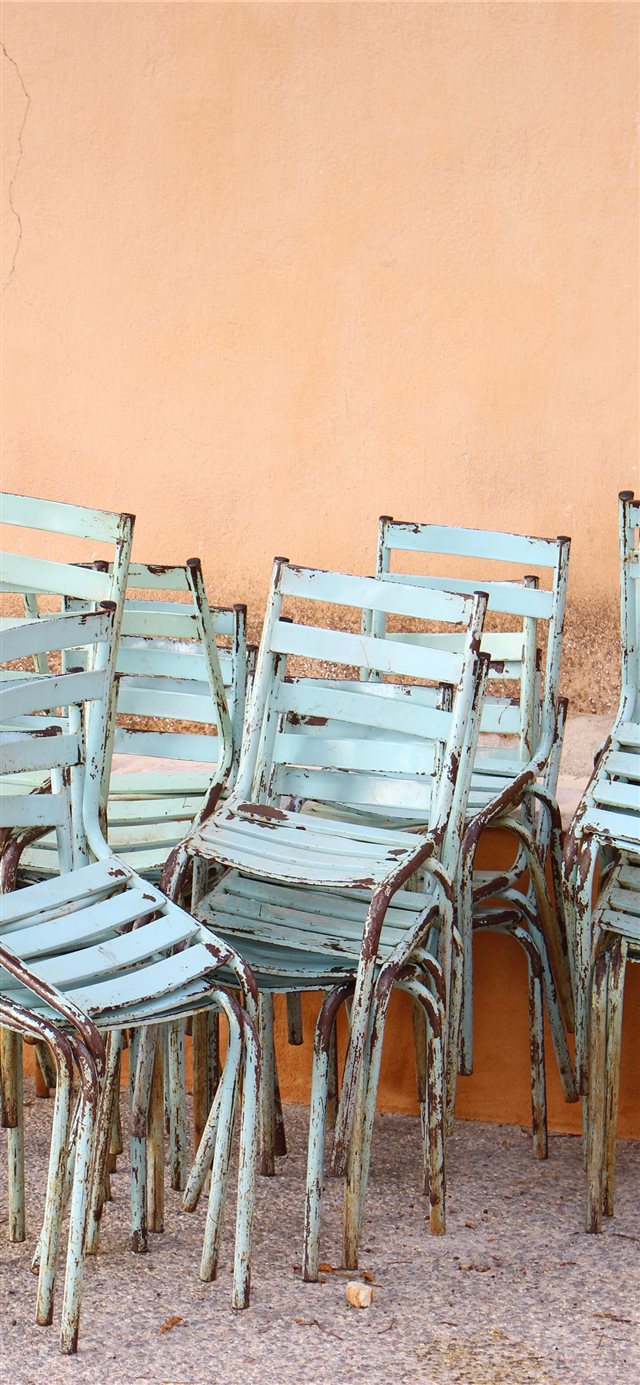 1125x2436 Stacked chairs in Greece - restaurant iPhone X Wallpaper