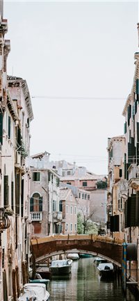 Laundry hanging over Venetian canal and bridge wallpaper