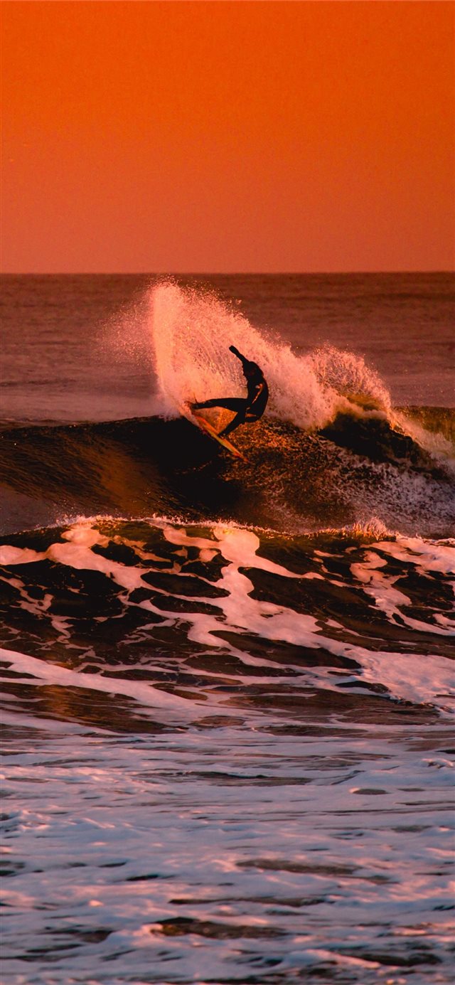 1125x2436 person surfing during sunset - water iPhone X Wallpaper