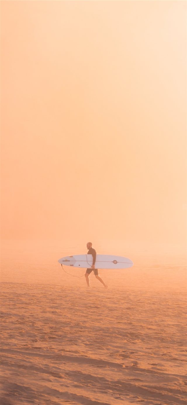 1125x2436 man carrying surfboard -  iPhone X Wallpaper