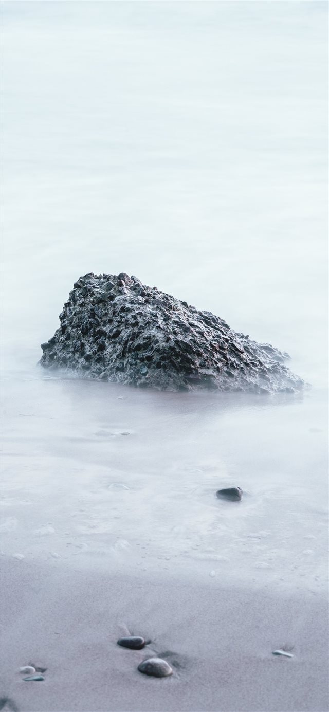 1125x2436 rock on sand shore during day - snow iPhone X Wallpaper