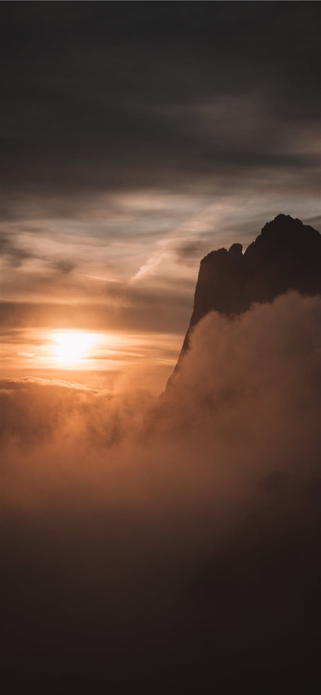 1125x2436 silhouette of mountain under cloudy sky - sun iPhone X Wallpaper