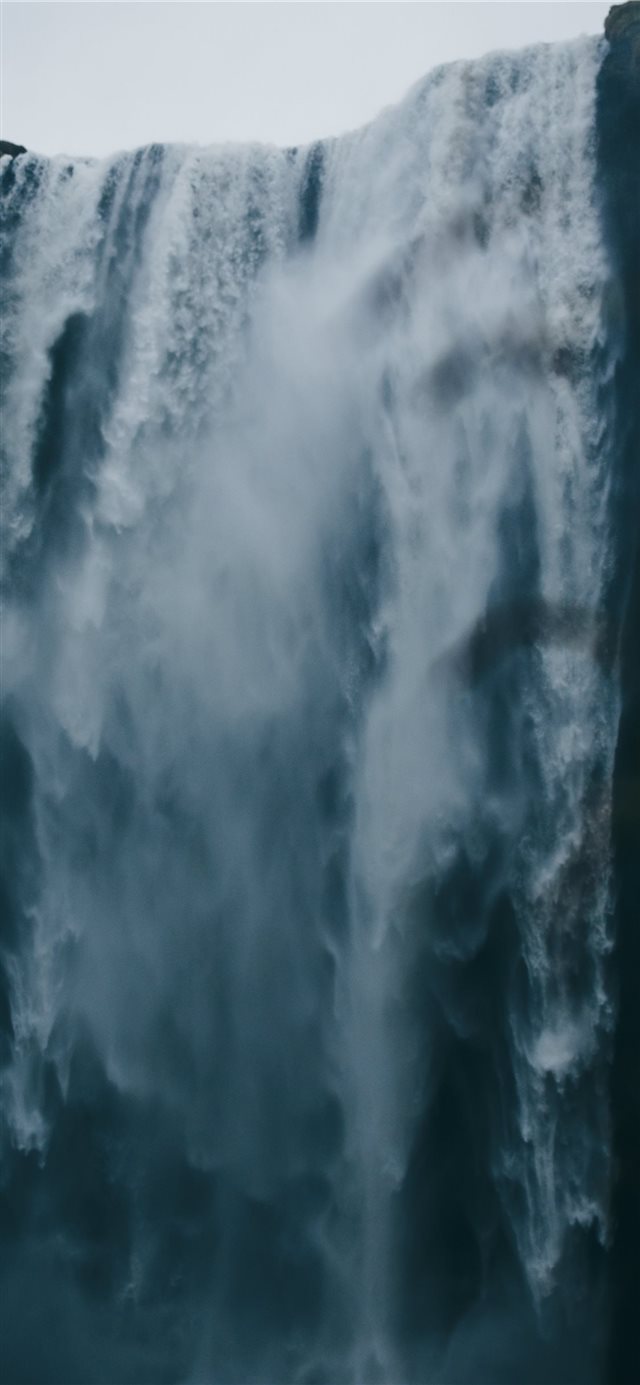 1125x2436 low angle photography of waterfall - skógafoss iPhone X Wallpaper