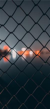 chain link fence behind bokeh wallpaper