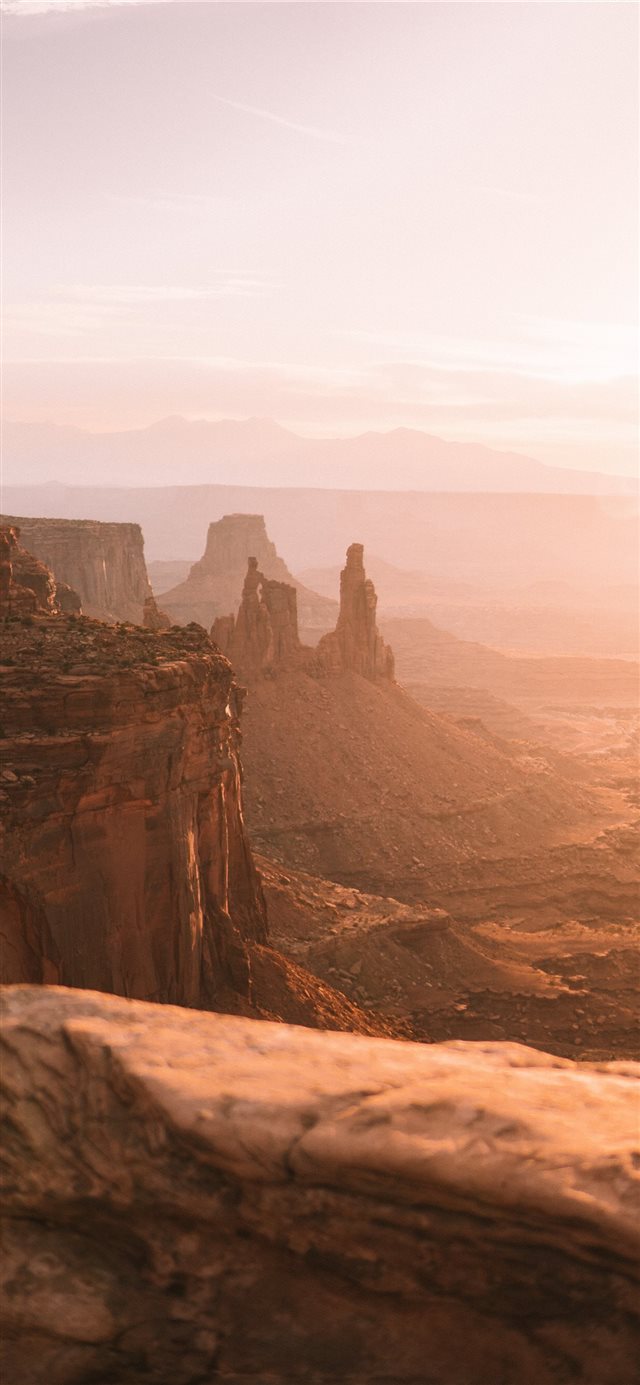 1125x2436 brown rock formation at daytime - grey iPhone X Wallpaper