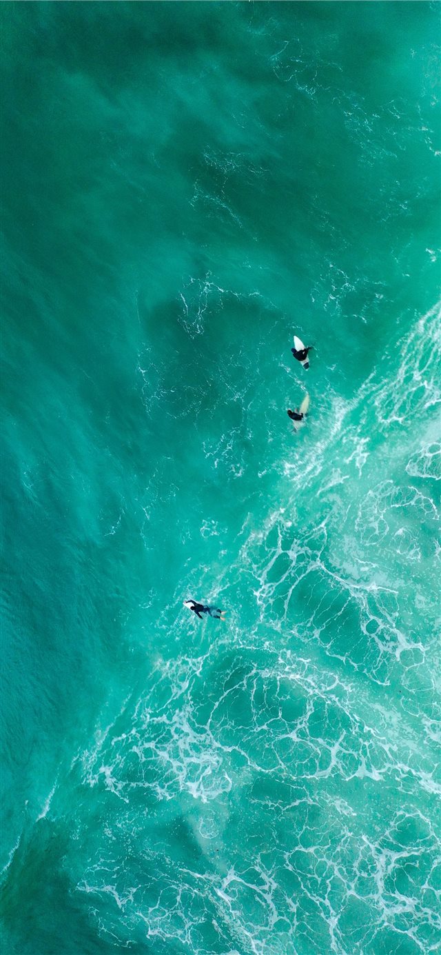 1125x2436 aerial photography of surfers on sea - blue iPhone X Wallpaper