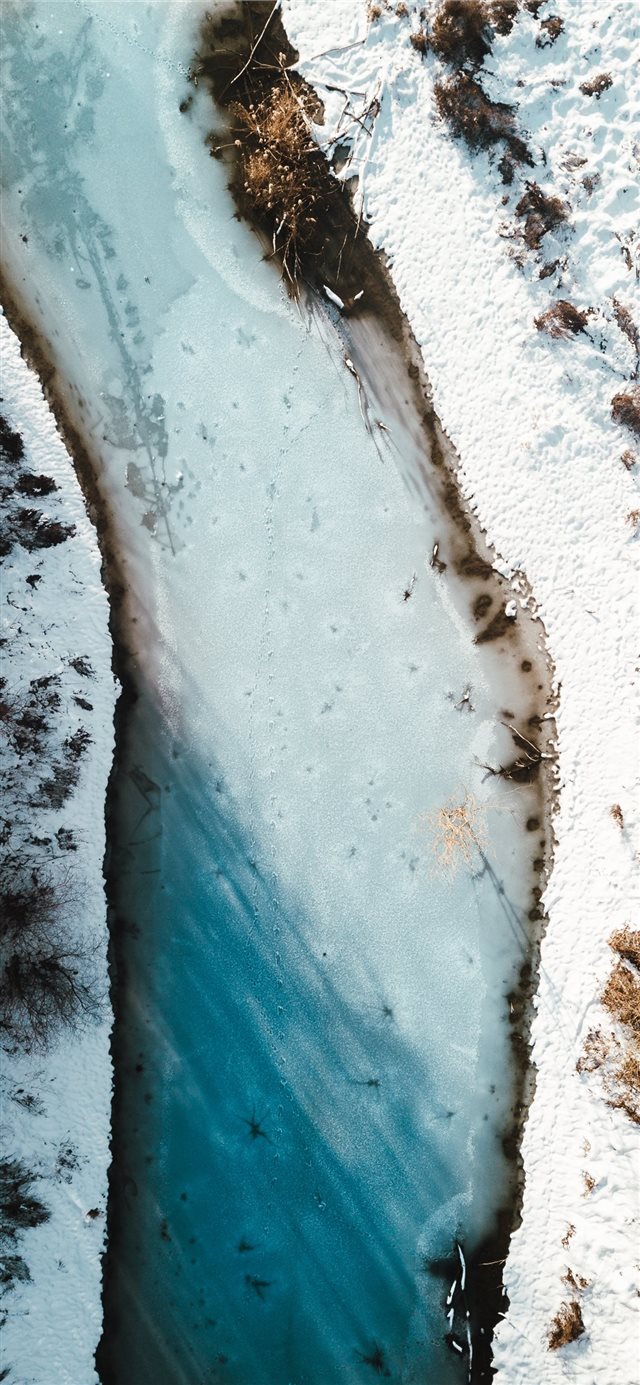 1125x2436 aerial photography of river beside snow field - winter iPhone X Wallpaper