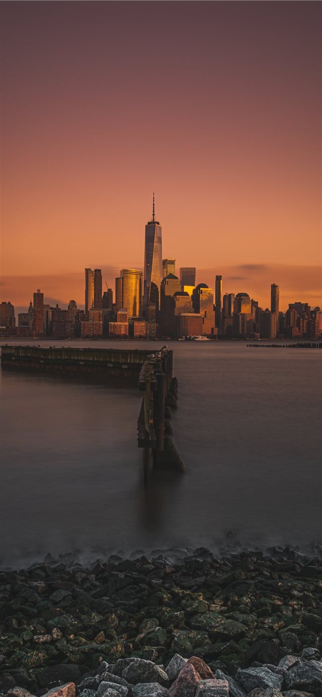 1125x2436 city and body of water during golden hour - water iPhone X Wallpaper