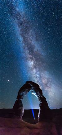 natural arch viewing milky way during night time wallpaper