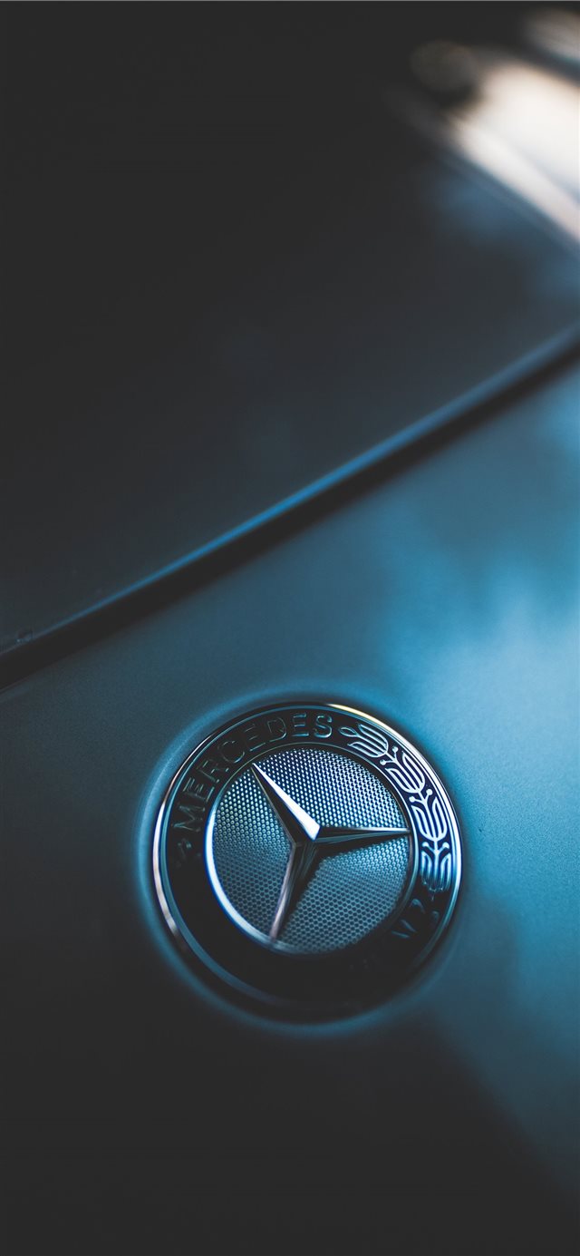 1125x2436 closeup photo of Mercedes Benz emblem - grey iPhone X Wallpaper