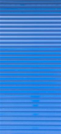 Blue roller shutter of a warehouse wallpaper