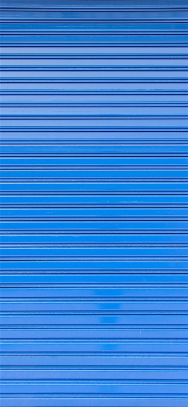 1125x2436 Blue roller shutter of a warehouse - window iPhone X Wallpaper