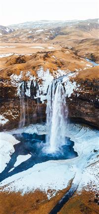 aerial photography of waterfalls near mountains at... wallpaper