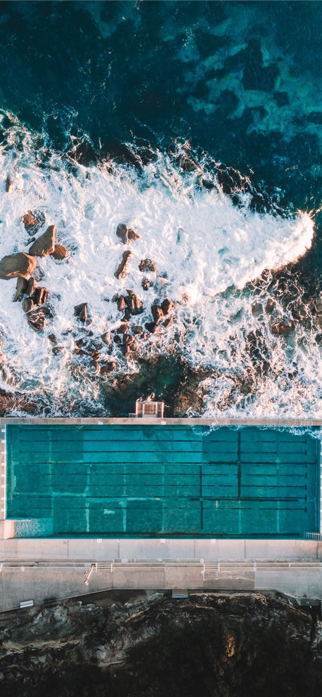 1125x2436 aerial photo of concrete building near sea - australia iPhone X Wallpaper