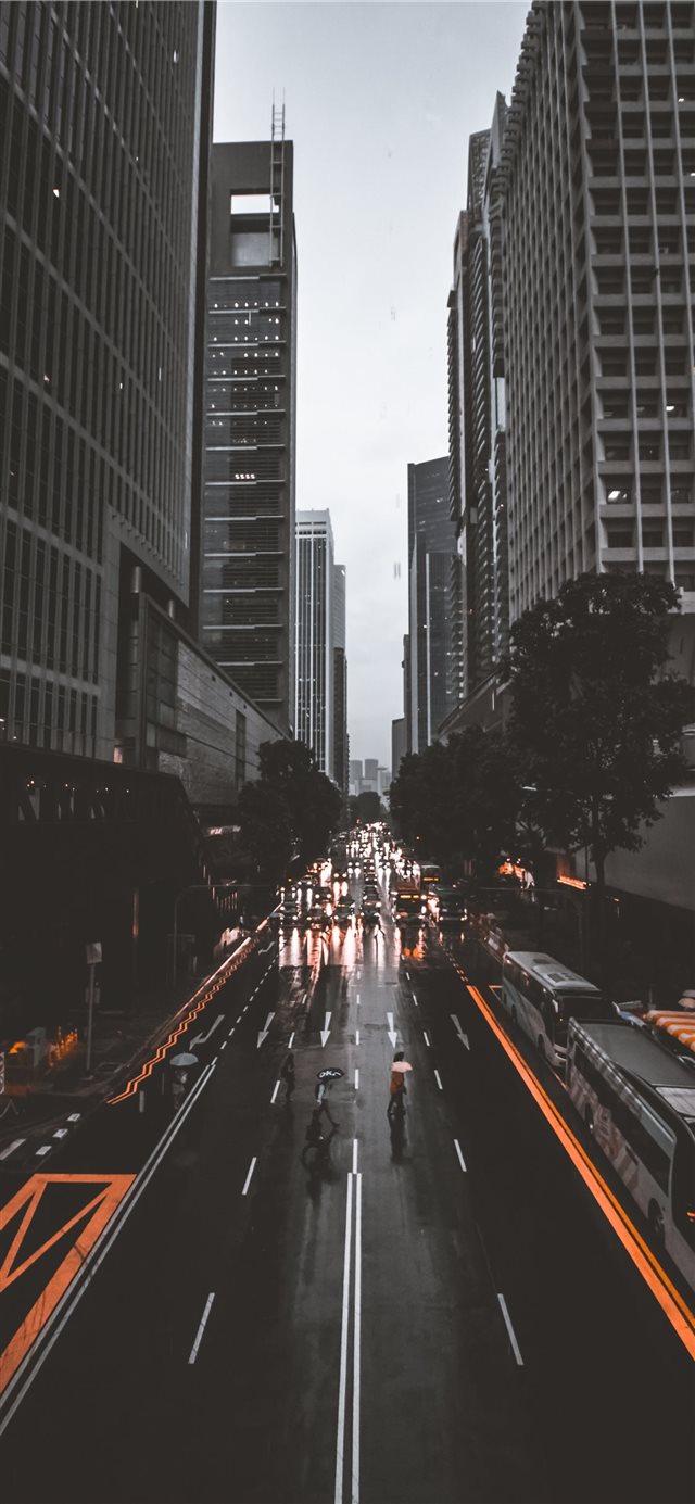 1125x2436 people crossing road between high rise buildings - yellow iPhone X Wallpaper