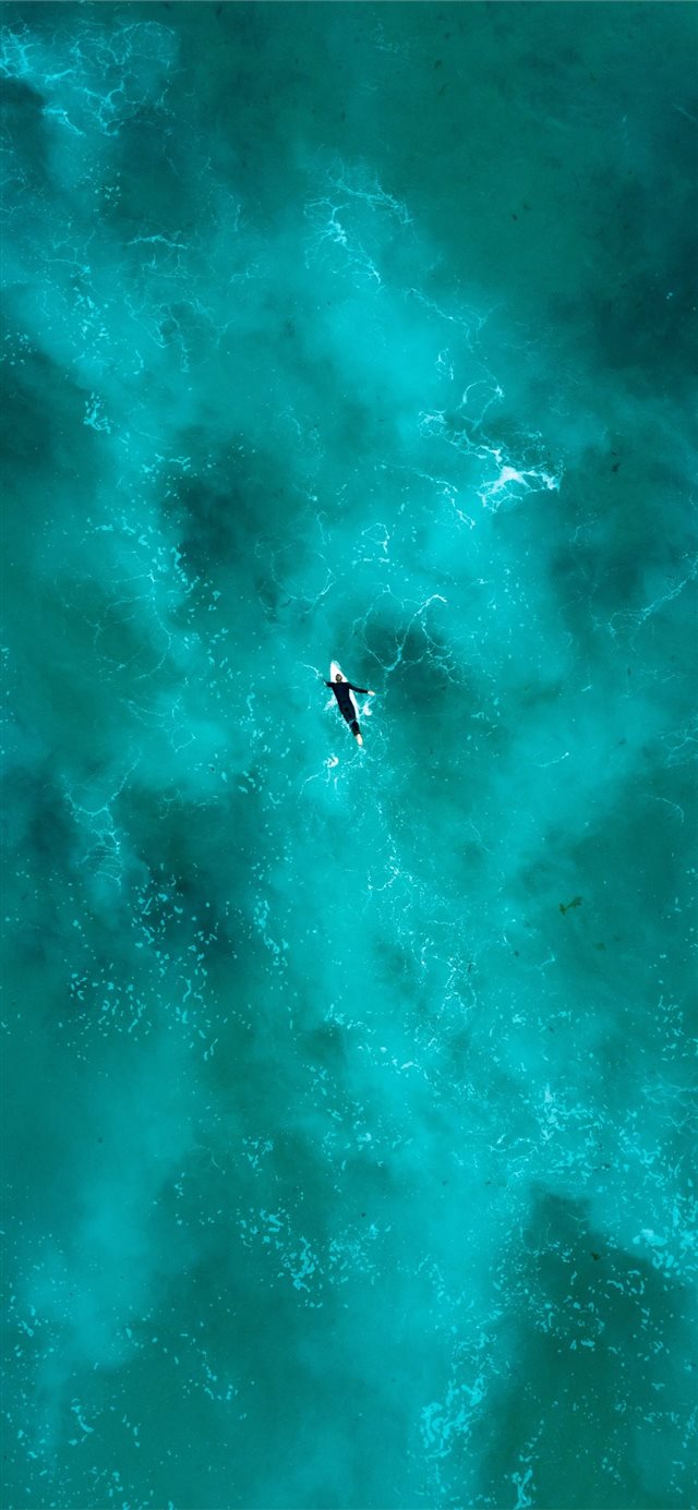 1125x2436 man surfing during daytime - space iPhone X Wallpaper