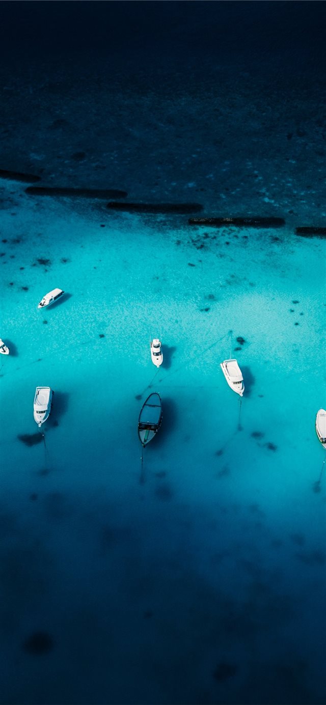1125x2436 aerial view photography of boat on body of water - water iPhone X Wallpaper