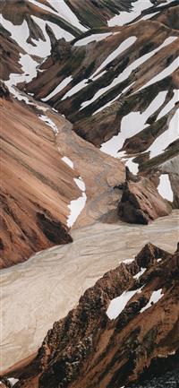 brown mountain covered by melting snow wallpaper