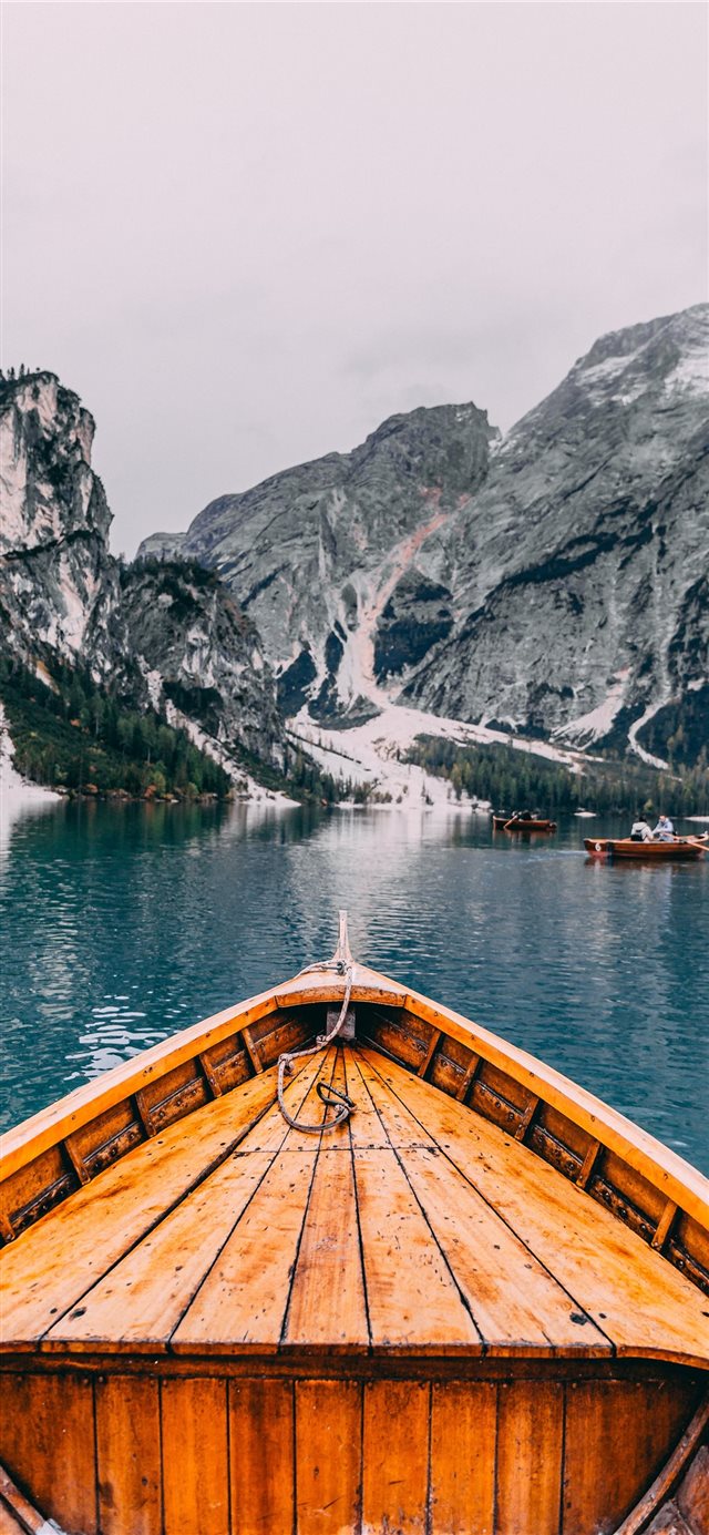 1125x2436 people in brown wooden boat - mountain iPhone X Wallpaper