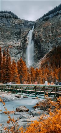 metal bridge near waterfall wallpaper