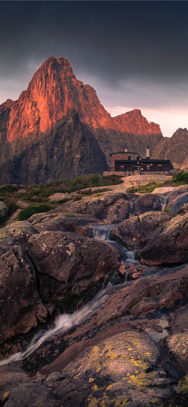 1125x2436 black building in front of mountain during golden ... - landscape iPhone X Wallpaper