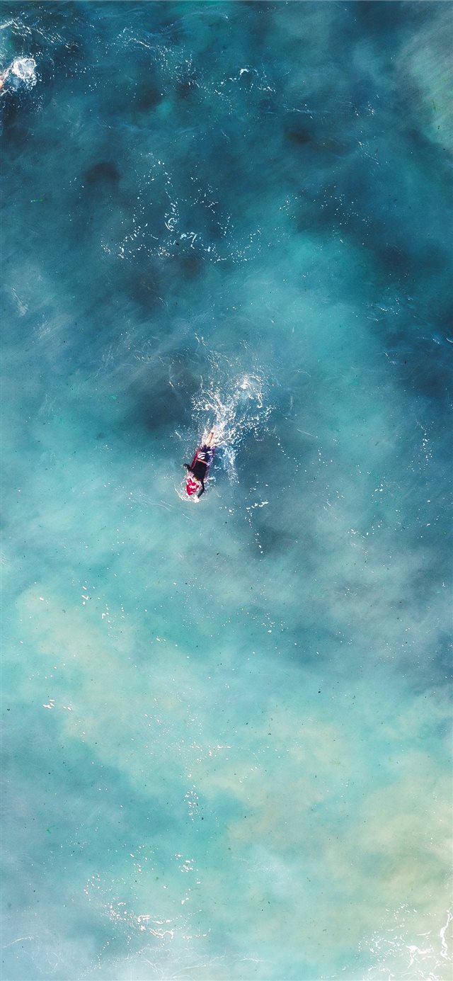 1125x2436 person in blue waters -  iPhone X Wallpaper