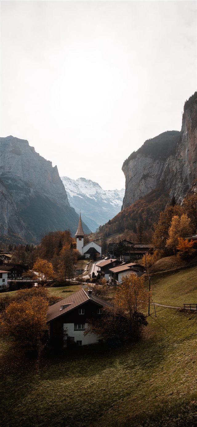 1125x2436 brown and white house near mountain during daytime - lauterbrunnen iPhone X Wallpaper