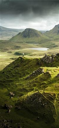 aerial view photography of person standing on moun... wallpaper