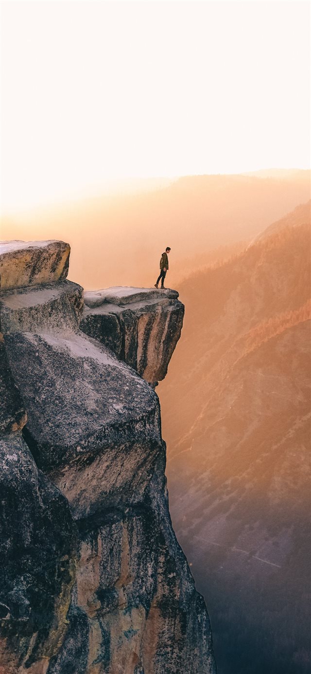 1125x2436 person standing near cliff - landscape iPhone X Wallpaper
