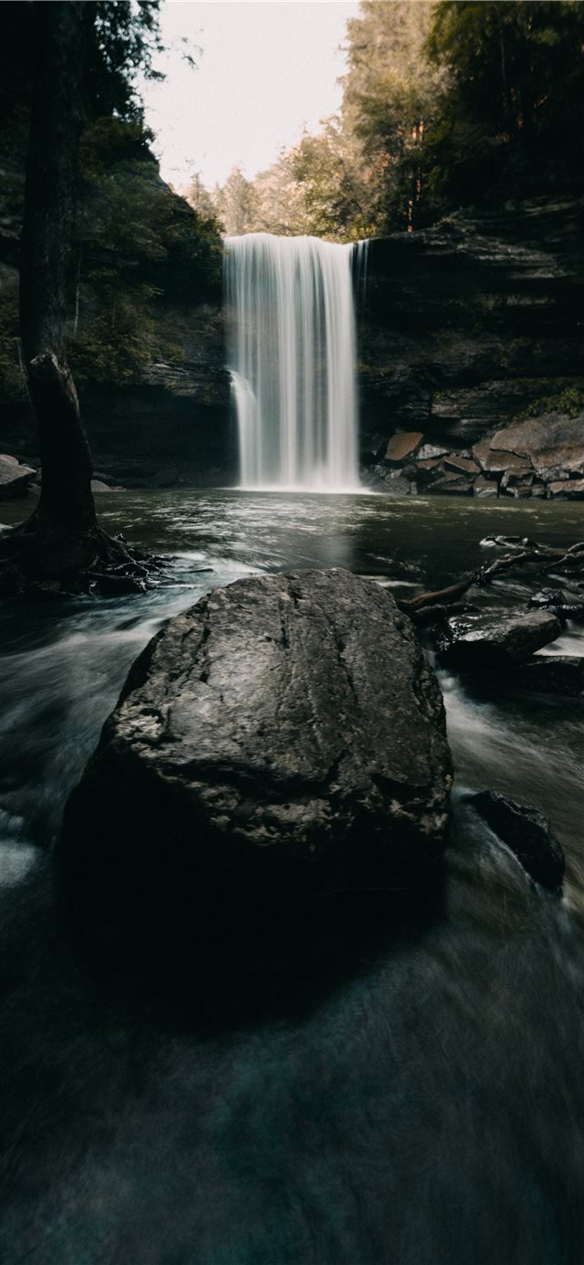 1125x2436 water falls on rocky shore during daytime - grey iPhone X Wallpaper