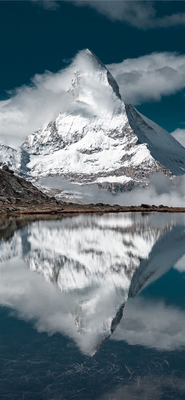 1125x2436 snow covered mountain near lake under blue sky dur... - snow iPhone X Wallpaper