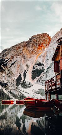 red boat on body of water near brown wooden house ... wallpaper