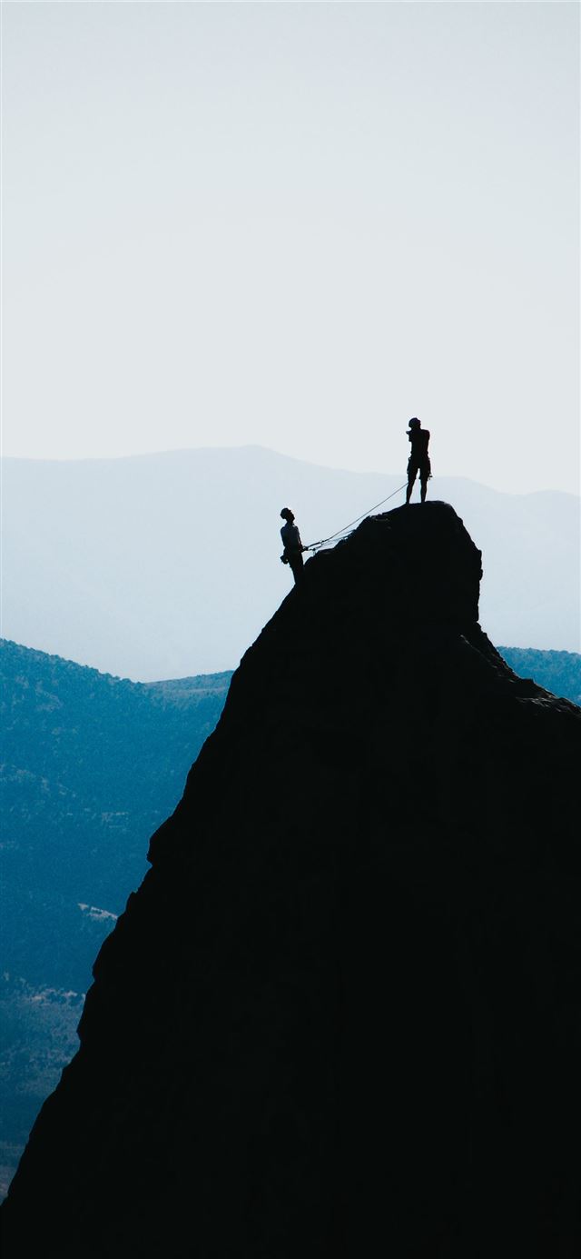 1125x2436 silhouette of two people standing on mountain duri... -  iPhone X Wallpaper