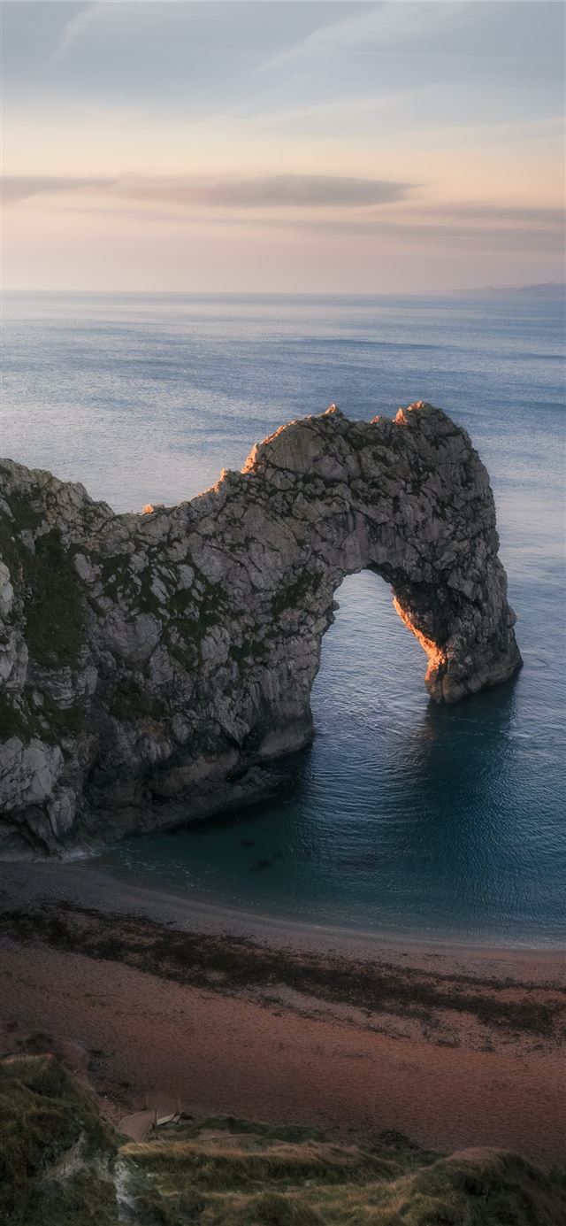 1125x2436 high angle photography of cliff and blue beach - grey iPhone X Wallpaper