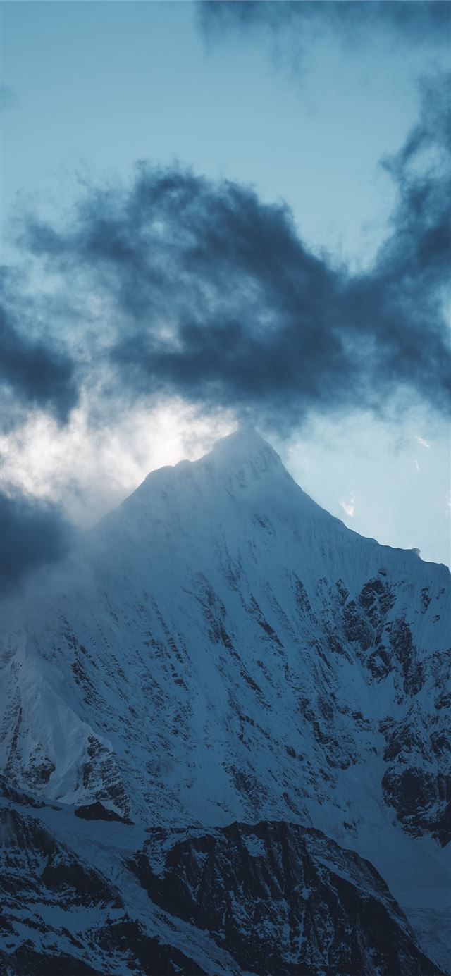 1125x2436 snow covered mountain under gray clouds at daytime - snow iPhone X Wallpaper