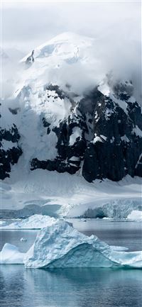 small iceberg beside large iceberg wallpaper