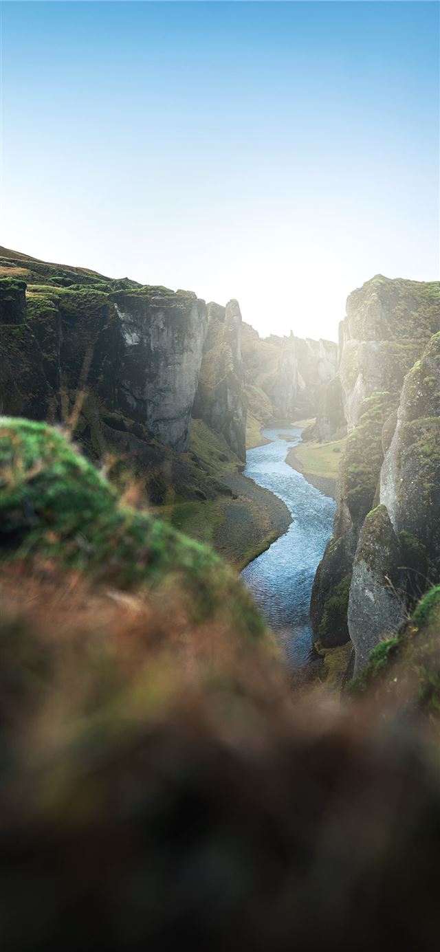 1125x2436 river between green grass covered mountain during ... - mountain iPhone X Wallpaper