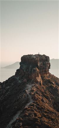 brown rock formation on sea during daytime wallpaper