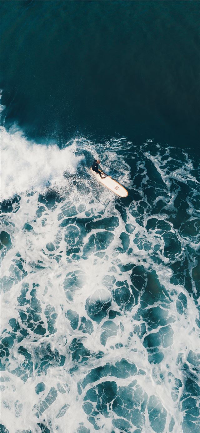 1125x2436 person surfing on sea waves during daytime - water iPhone X Wallpaper
