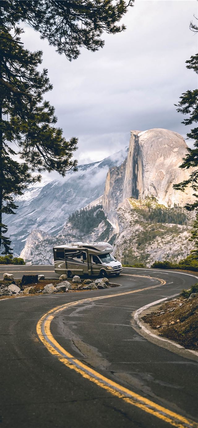 1125x2436 black suv on road near trees and snow covered moun... - tree iPhone X Wallpaper