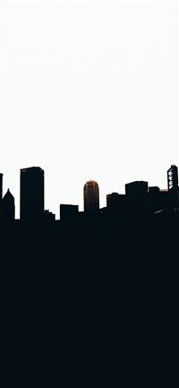 silhouette of city buildings during daytime wallpaper