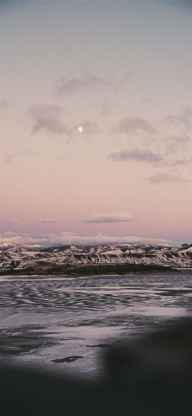 1125x2436 grayscale photo of body of water and rocks - sky iPhone X Wallpaper