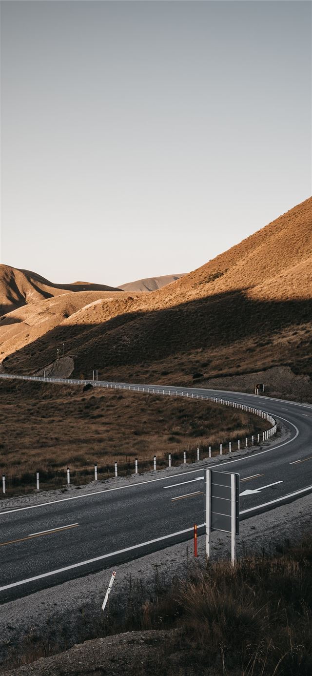 1125x2436 gray asphalt road between brown mountains during d... -  iPhone X Wallpaper
