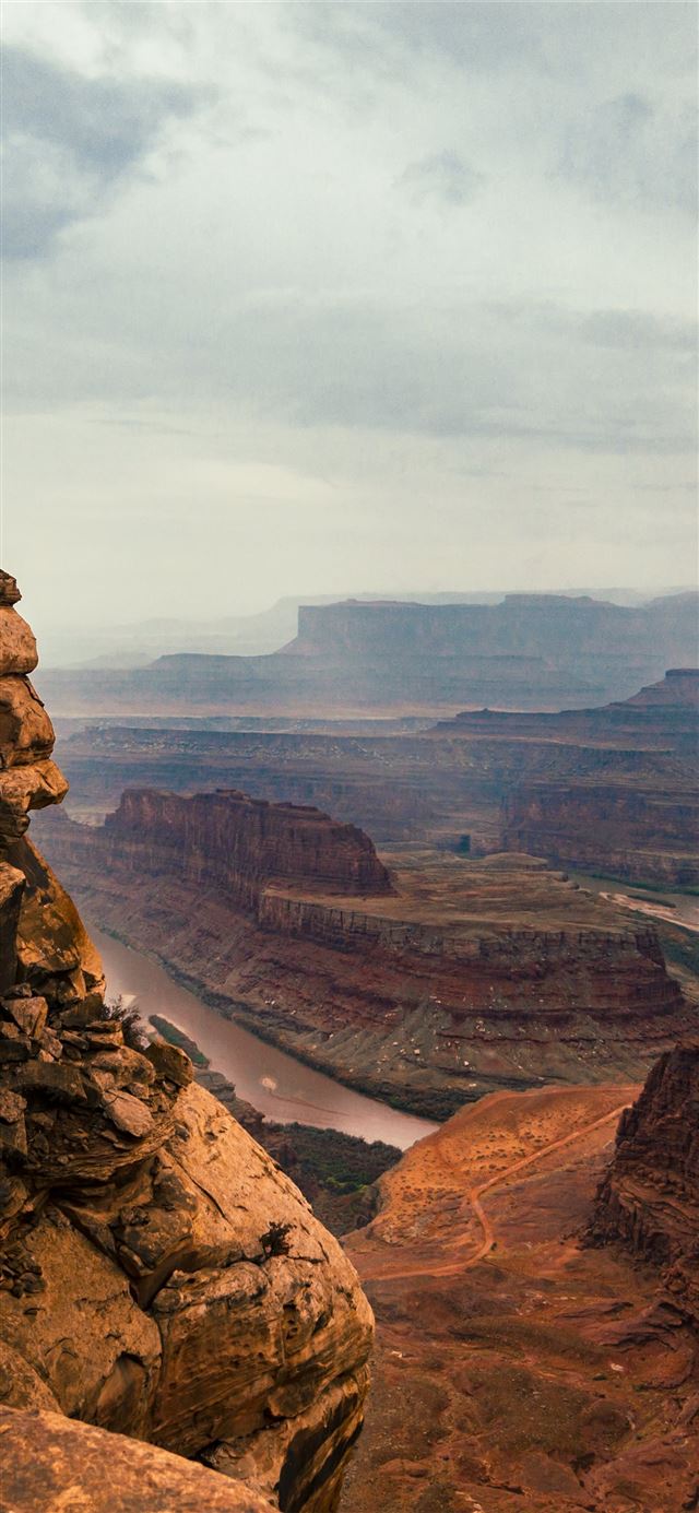 1125x2436 man standing on cliff -  iPhone X Wallpaper