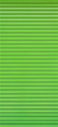 Green roller shutter of a warehouse wallpaper