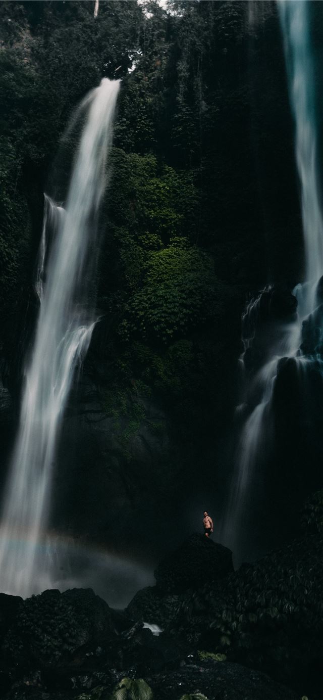 1125x2436 people sitting on rock in front of waterfalls duri... - water iPhone X Wallpaper
